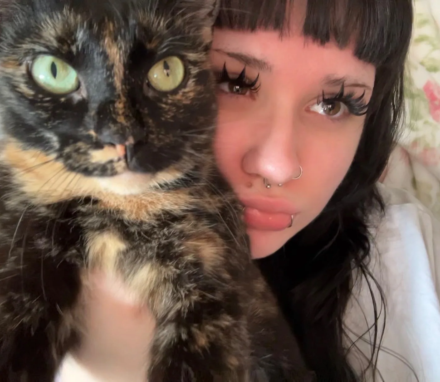 Arianna cheek to cheek with one of her cats.